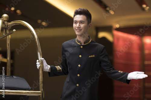 Cheerful bell boy greeting