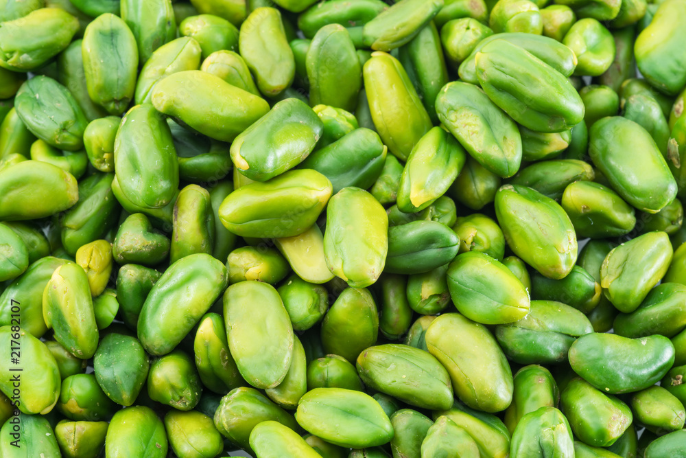 Lot of green pistachio nuts. Food background. Lot of green pistachio nuts. Food background.
