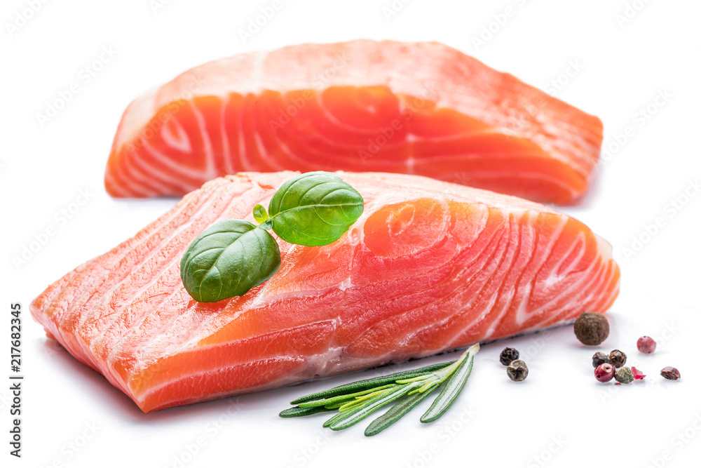 Fresh raw salmon fillets with herbs and spices.