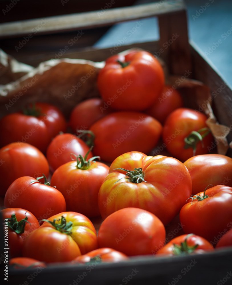 Fresh organic tomatoes in the wooden box,closeup,shallow depth of field Fresh organic tomatoes in the wooden box,closeup,shallow depth of field
