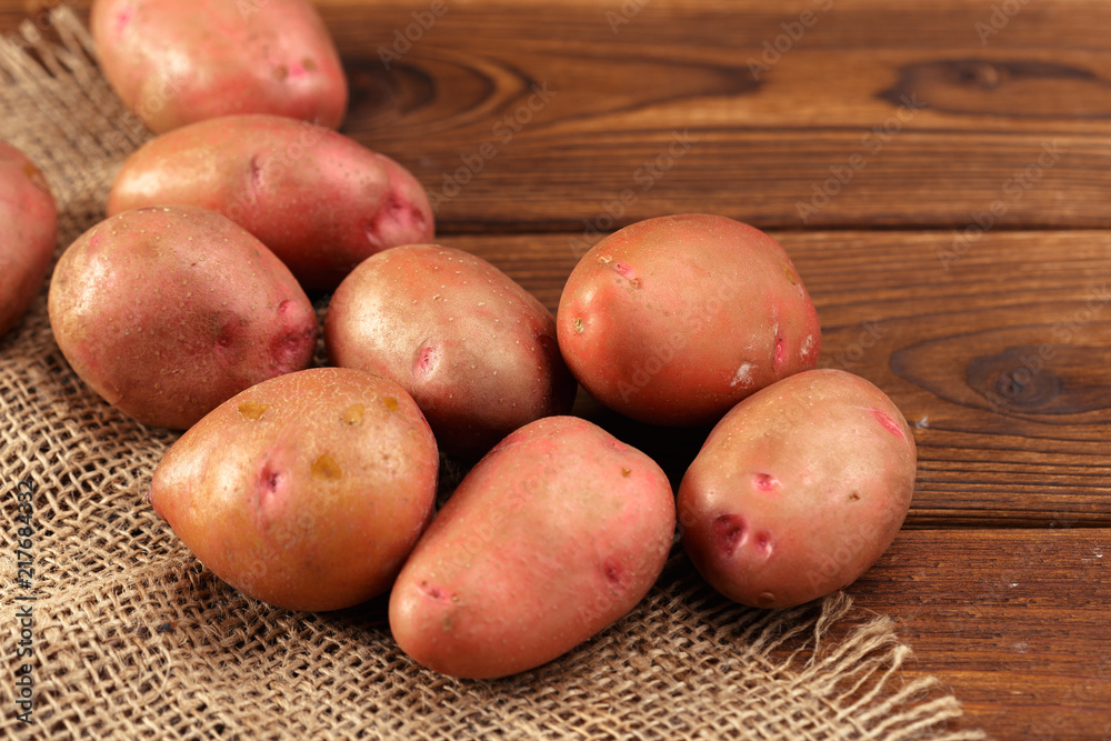 Pile of potatoes lying on wooden boards
