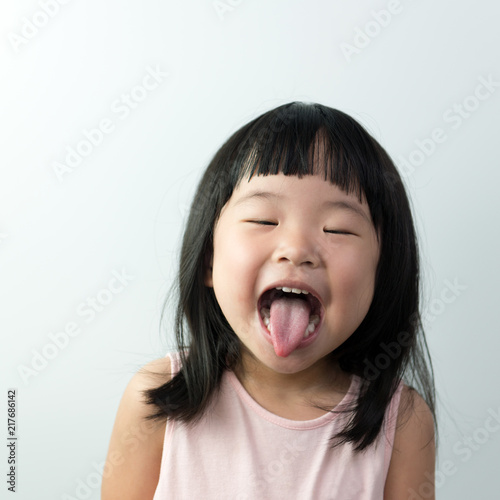 Happy little asian girl with funny face isolated on white background