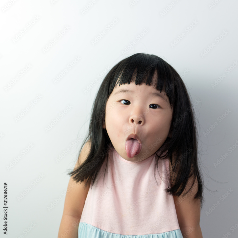 Happy little asian girl with funny face isolated on white background Stock  Photo | Adobe Stock