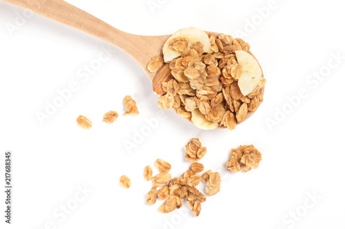 Close up Granola on the wooden spoon isolated on white background.