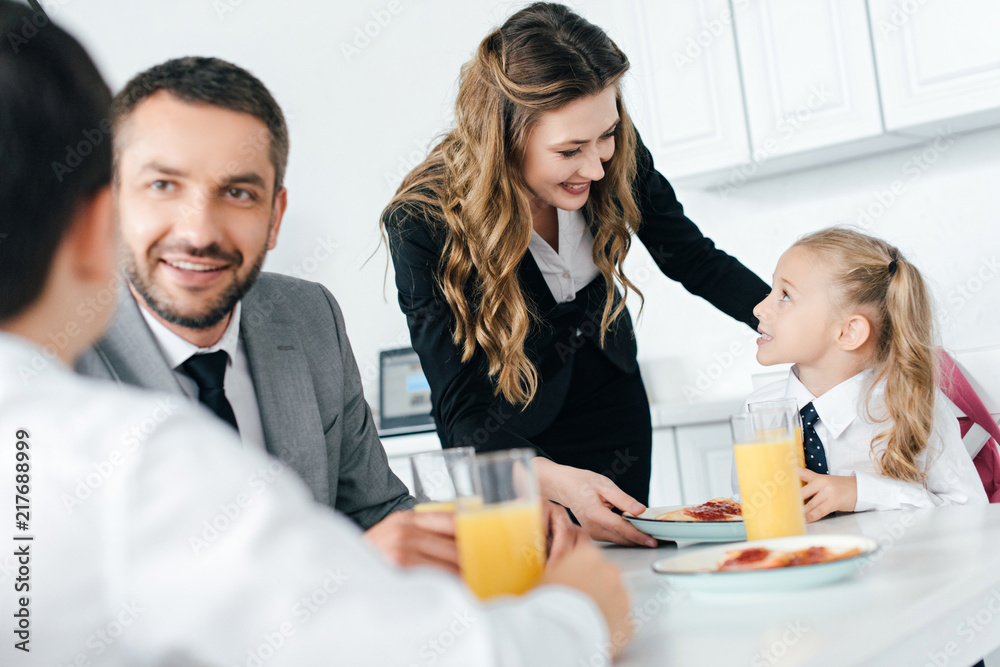 family having breakfast in kitchen at home on first school day family having breakfast in kitchen at home on first school day