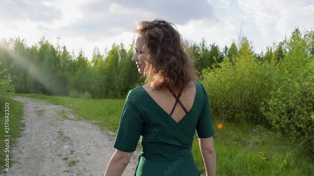 Happy woman walking in the park, camera stabilizer shot Happy woman walking in the park, camera stabilizer shot