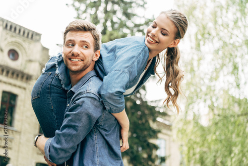 happy young man carrying his girlfriend on shoulder at park © LIGHTFIELD STUDIOS