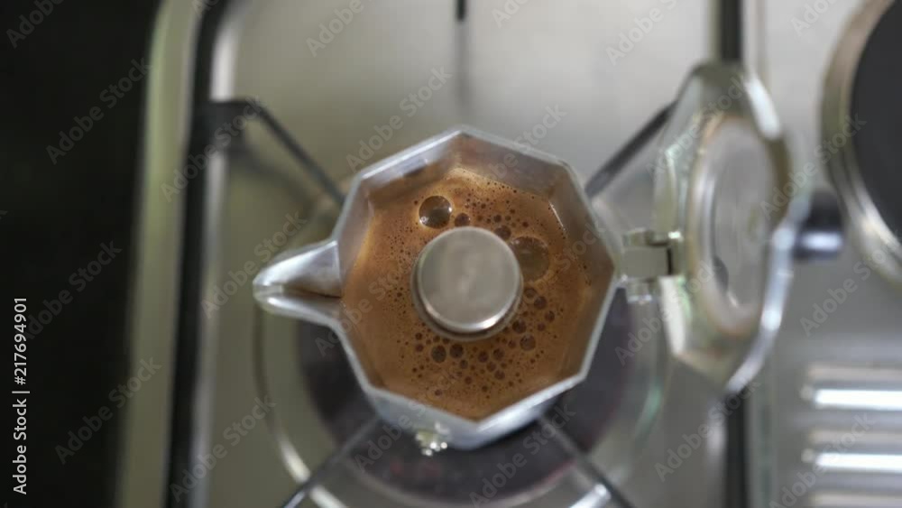 Italian Espresso coffee extraction in moka pot, top view angle footage Italian Espresso coffee extraction in moka pot, top view angle footage