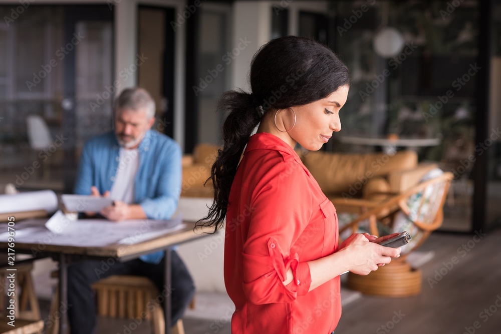Office executive using mobile phone at creative office