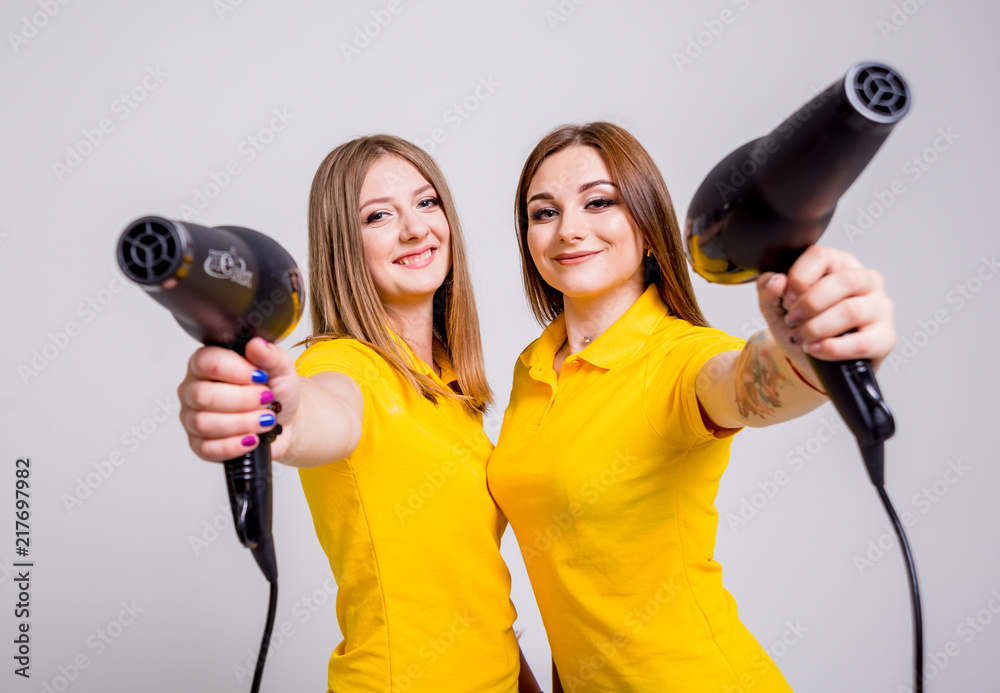 Two young groommers with tolls on the white background.