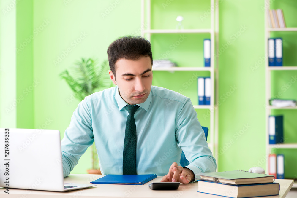 Male financial manager working in the office Male financial manager working in the office