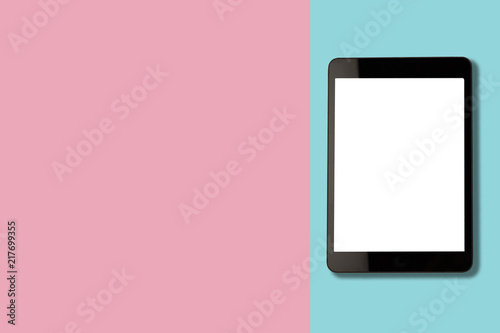 Digital tablet with blank screen on pastel color background, flat lay photo