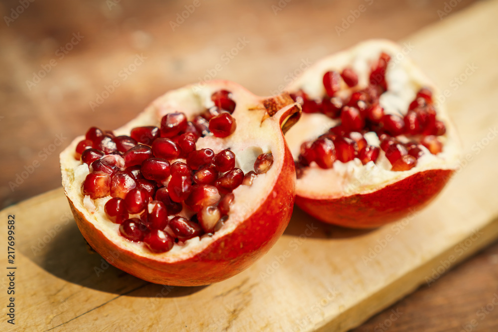 fresh pomegranate fruit on an old wooden table fresh pomegranate fruit on an old wooden table