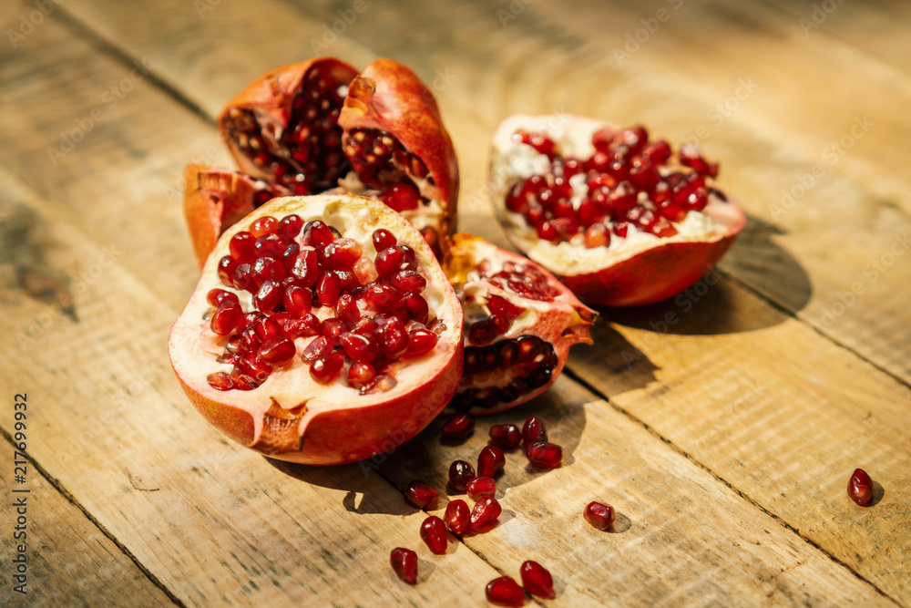 fresh pomegranate fruit on an old wooden table fresh pomegranate fruit on an old wooden table