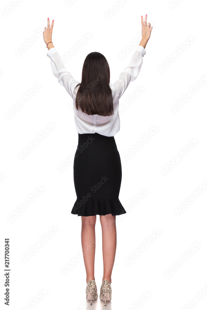 backv view of businesswoman celebrating with hands in the air