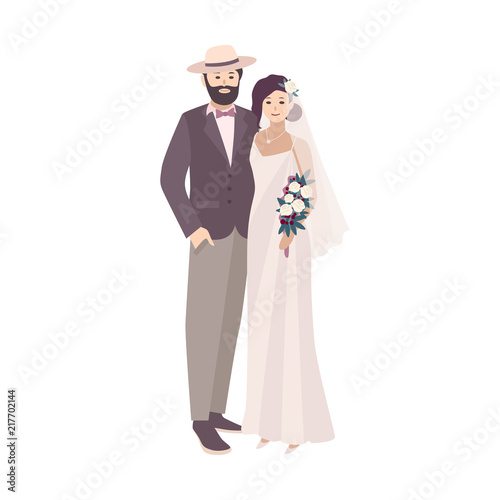Elegant bride dressed in fancy vintage gown and groom wearing stylish suit and hat