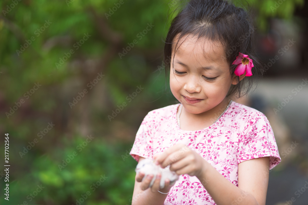 Beautiful asian little girl has fun smile face, happy eyes and lovingly embraces her pet rat. Beautiful asian little girl has fun smile face, happy eyes and lovingly embraces her pet rat.