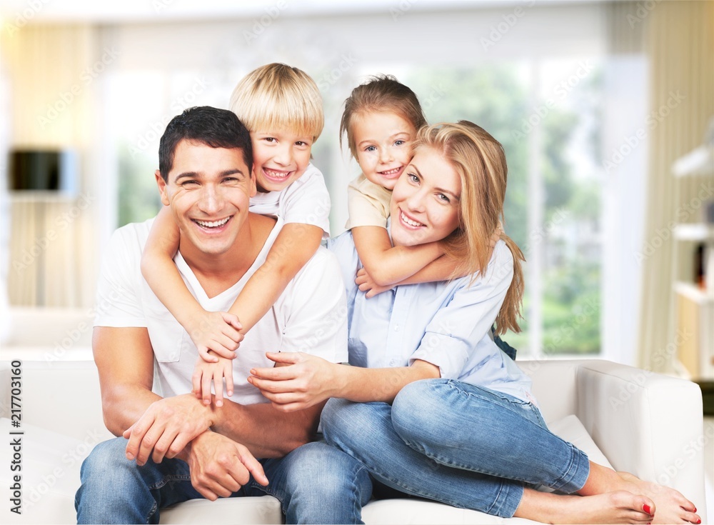 Young family at home smiling at camera Young family at home smiling at camera