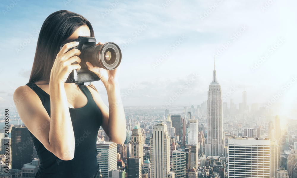 Woman taking photo on city background