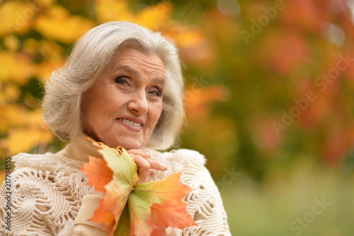 Portrait of a woman holding autumn leaves