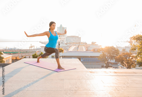 Young woman doing yoga in morning park