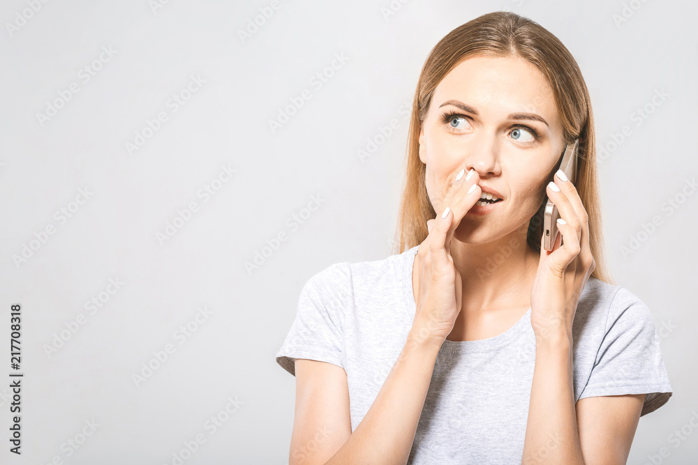 Top secret! Portrait of Beautiful Young Business woman using mobile phone isolated on white background Top secret! Portrait of Beautiful Young Business woman using mobile phone isolated on white background
