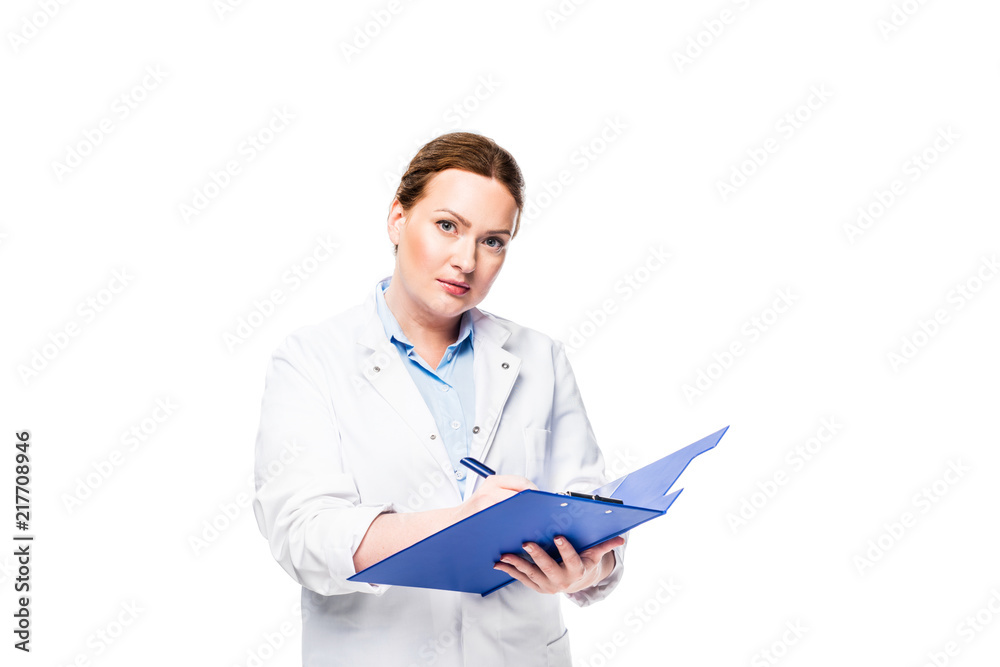 serious female doctor in white coat writing in clipboard isolated on white background serious female doctor in white coat writing in clipboard isolated on white background
