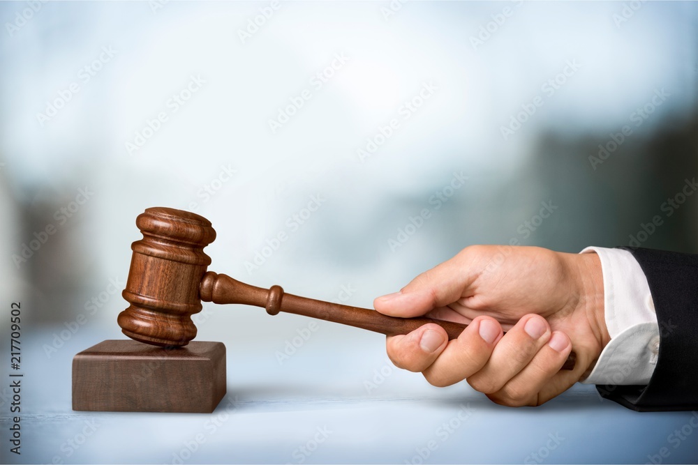 Male hand with wooden judge hammer Male hand with wooden judge hammer