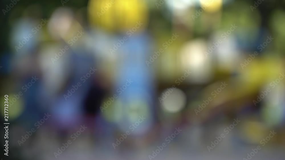 Defocused people, walking on footpath in public park Defocused people, walking on footpath in public park