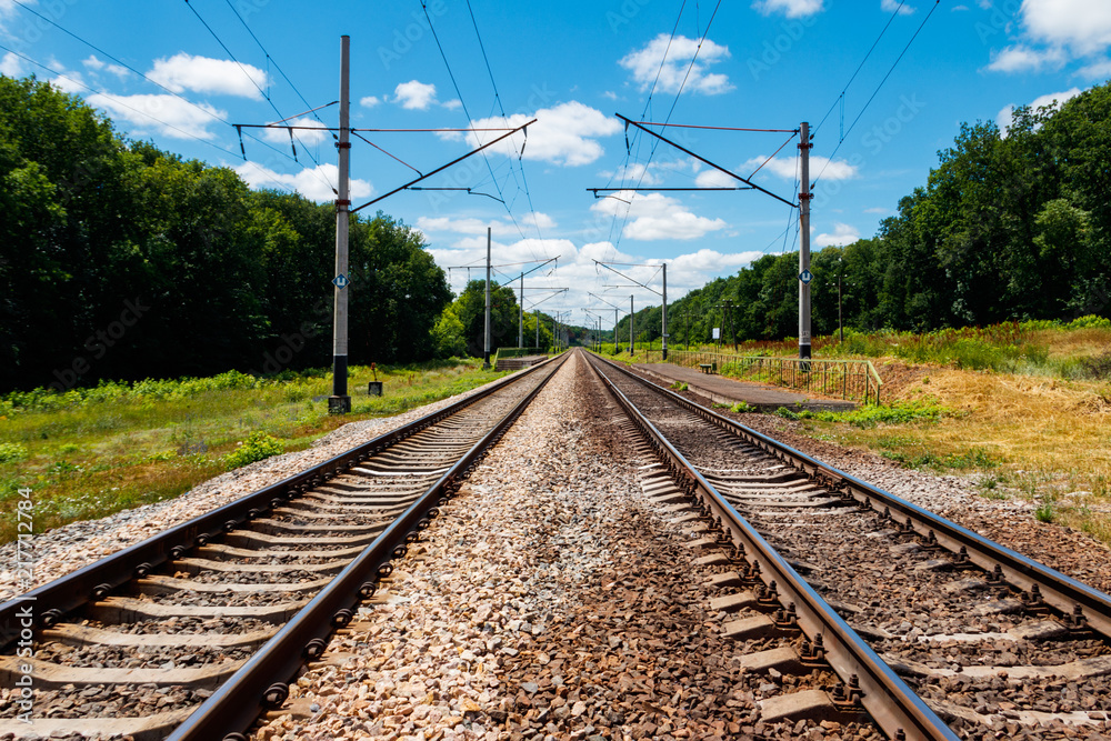 Scenic railroad in rural area and blue sky with white clouds in summer Scenic railroad in rural area and blue sky with white clouds in summer