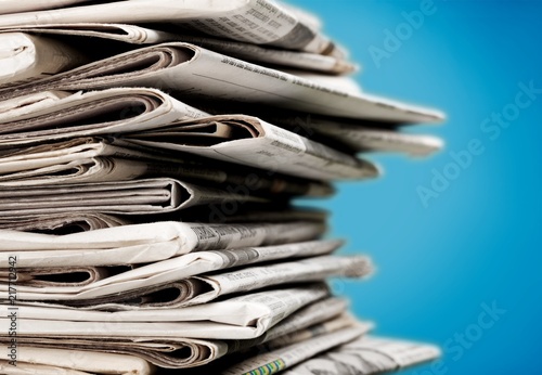 Pile of newspapers on white background