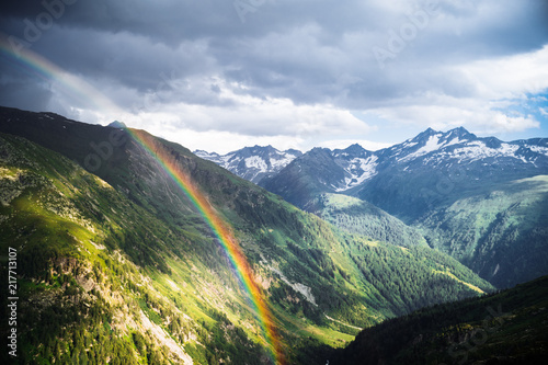 Rainbow in the mountain valley after rain. Grimselpass  Switzerland