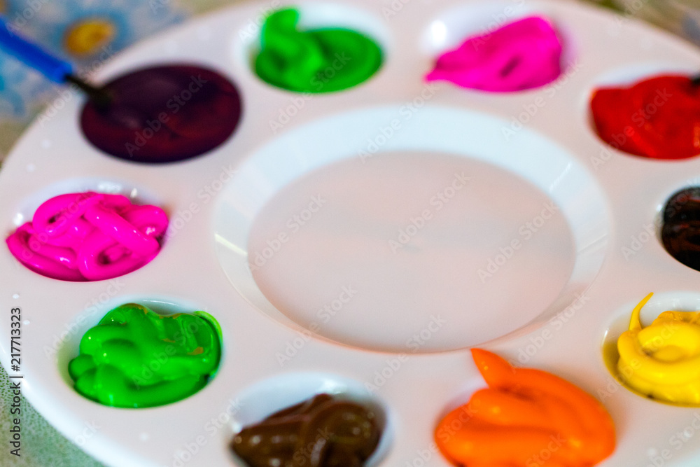 art palette with paint color and paint brushes close-up art palette with paint color and paint brushes close-up