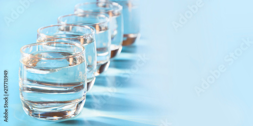 Glasses of water on blue. Close up. Copy space. Water balance for healthy.
