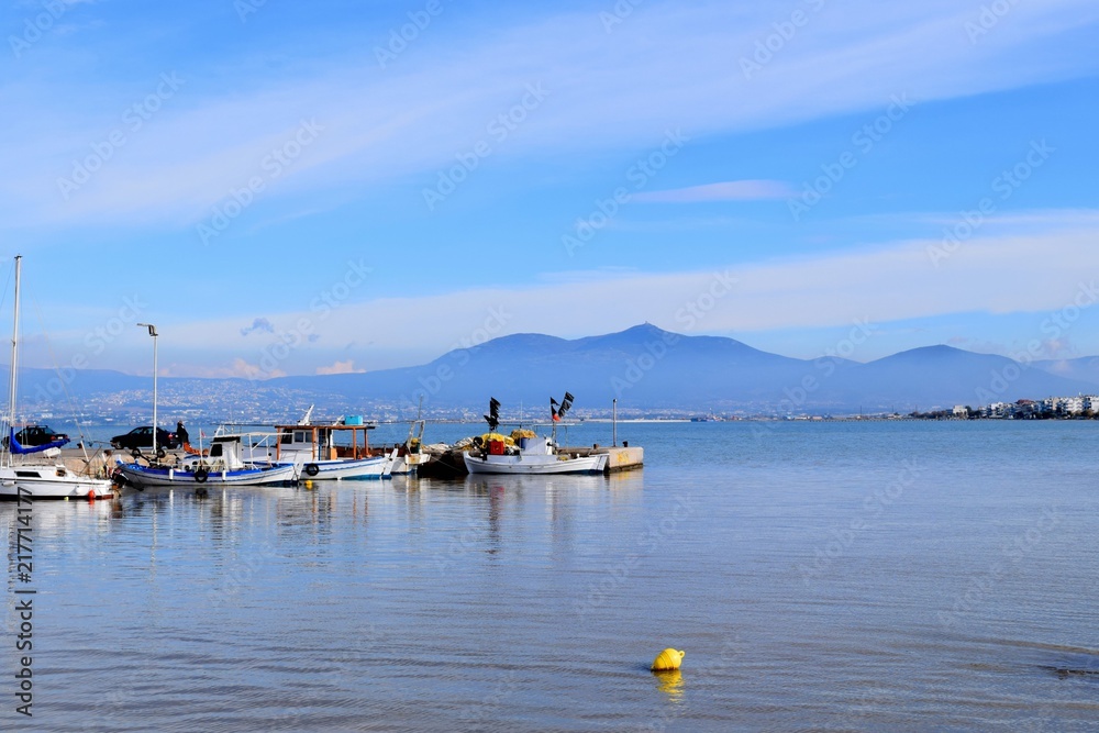 Fishing boats in the blue Aegean Sea. Peraia, Thessaloniki, Greece