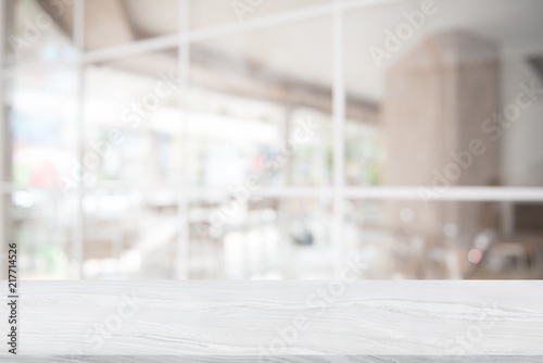 White marble table top on blur coffee shop
