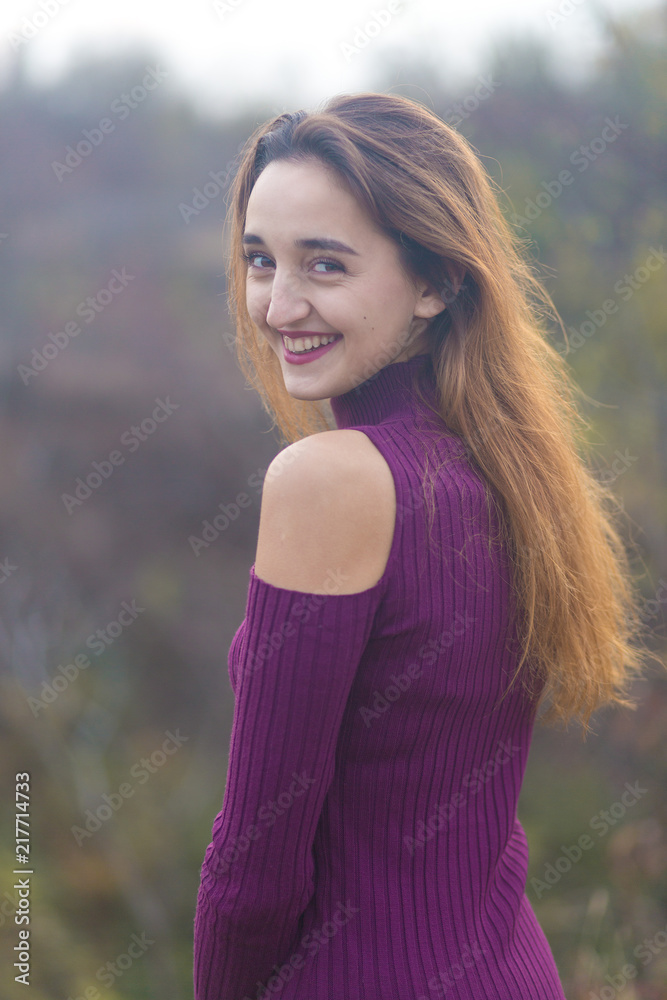 Girl in lilac dress on nature in autumn, Portrait of a beautiful girl in the autumn in the forest	