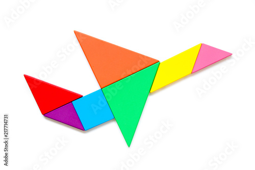 Color wood tangram puzzle in airplane shape on white background