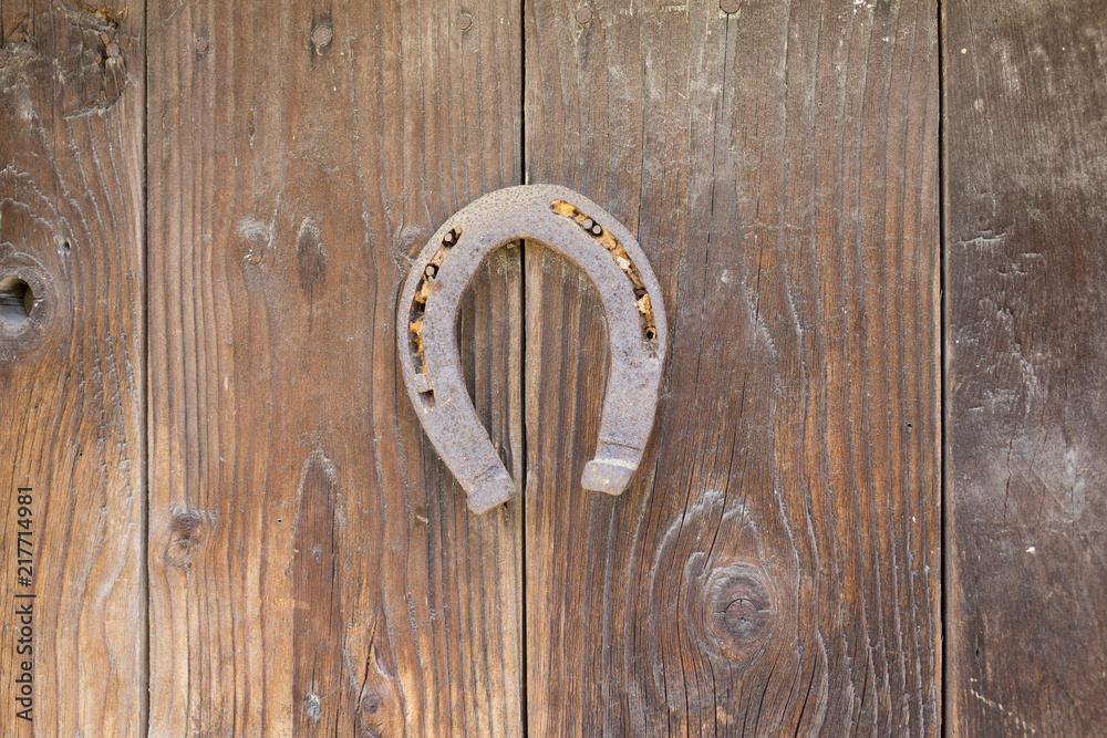 A rusty horseshoe fixed on old farm wal A rusty horseshoe fixed on old farm wal