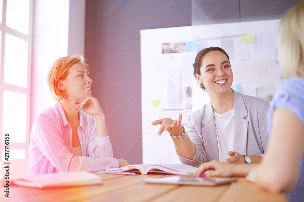 Young people studying with books on desk. Beautiful women and men working together Young people studying with books on desk. Beautiful women and men working together