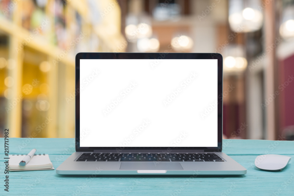 Computer notebook and mouse with a coffee shop behind the scenes Blur coffee shop Computer notebook and mouse with a coffee shop behind the scenes Blur coffee shop