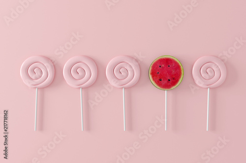 Watermelon candy on pastel pink background. different concept. minimal fruit photo