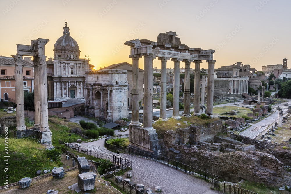 Sunrise over Rome. There are ancient ruins in foreground