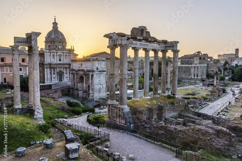 Sunrise over Rome. There are ancient ruins in foreground