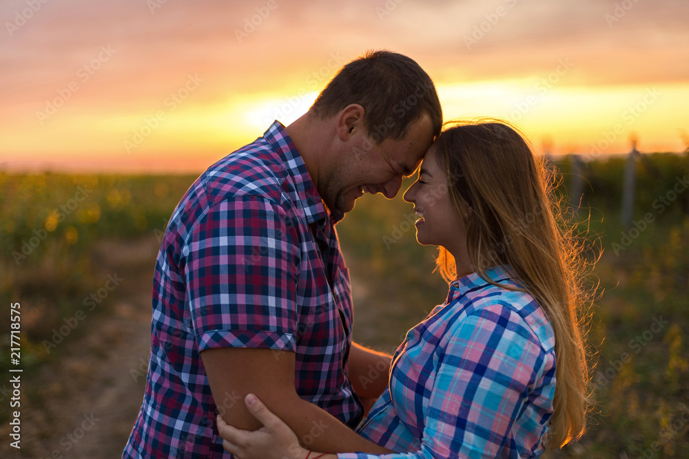 Young romantic couple in a field of sunflowers, pregnant girl in sunflowers Young romantic couple in a field of sunflowers, pregnant girl in sunflowers