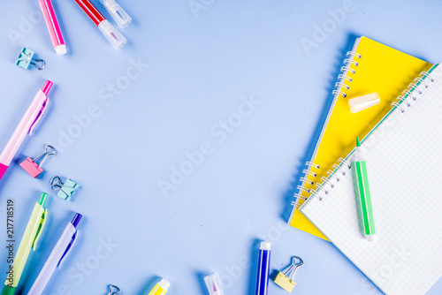 Back to school background, with bright accessories supplies for school and study - pen, pencils, markers, pencils, rulers, paperclips, sticks, notebooks, top view, free copy space for text