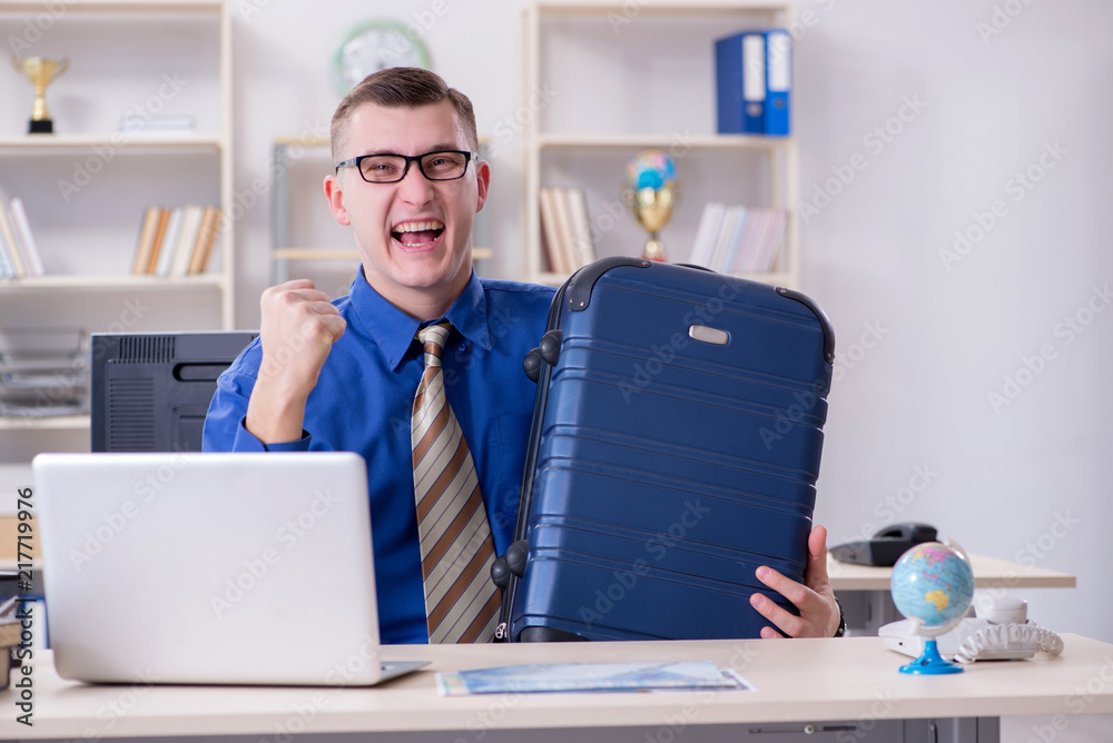 Young employee preparing for vacation trip 