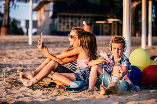 Children playing with mobile phones and tablet