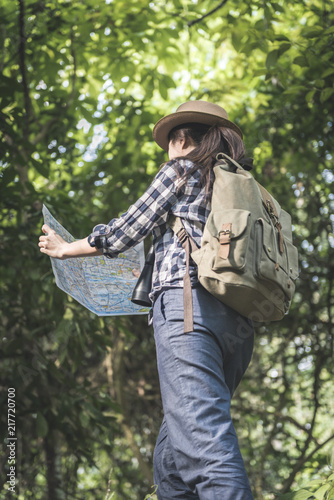 Woman traveler attractive adventure wilderness holding map. traveler Concept.