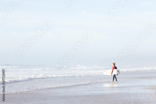 Surfer entering water